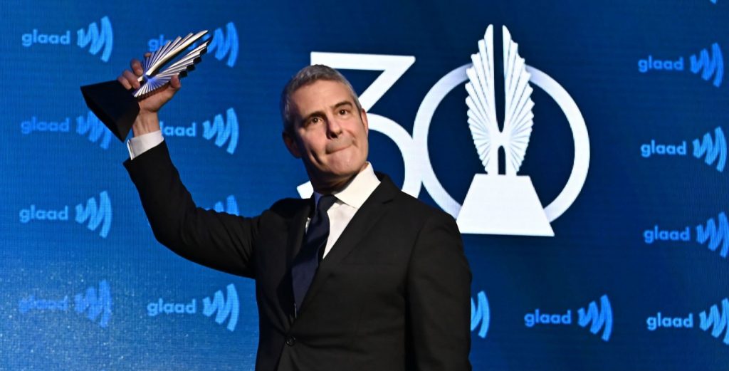 andy cohen celebrates with an award